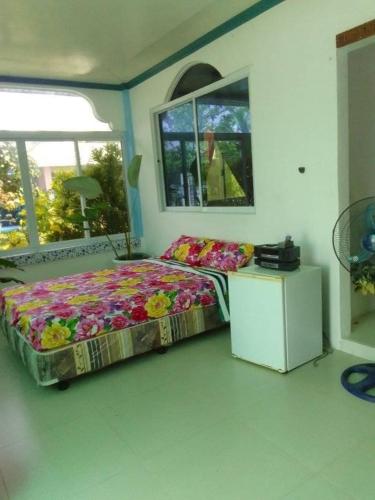 a bedroom with a bed in a room with windows at Joy o hoy beachfront house in Santander
