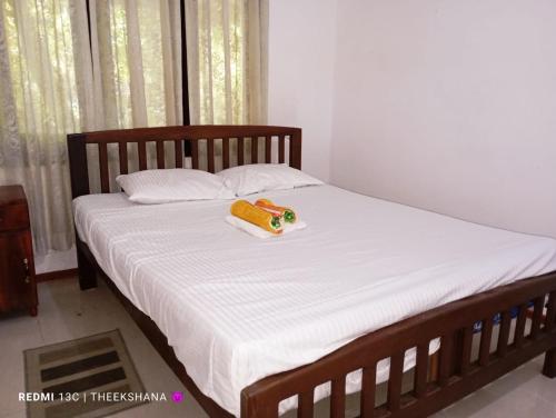 a bed with a banana and a toy on it at Villa Hasi in Habaraduwa Central