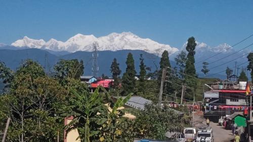 a view of a city with a mountain in the background at MARYBONG HOME STAY in Darjeeling