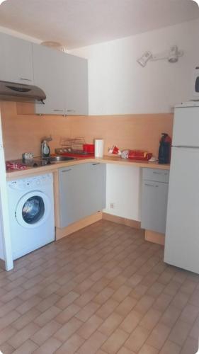 une cuisine avec un lave-linge et un lave-linge dans l'établissement Studio cabine Grau D Agde résidence avec piscine, au Grau-dʼAgde