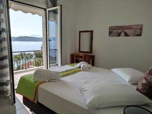 a bedroom with a bed with a view of the ocean at Korakias SeaView in Yenion