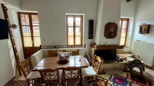 a living room with a table and a fireplace at Orechova - orech+ova in Arachova