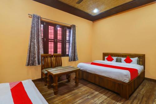 a bedroom with two beds and a window at OYO Hari Leela Home Stay in Haldwāni