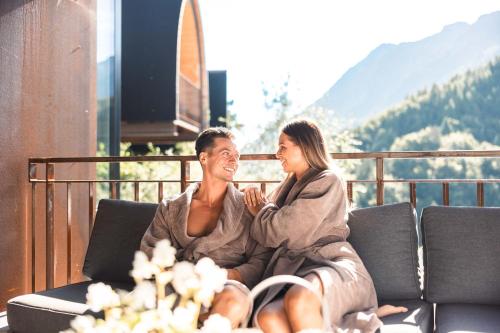 a man and a woman sitting on a couch at Himmelchalet - Alpencamping Nenzing in Nenzing