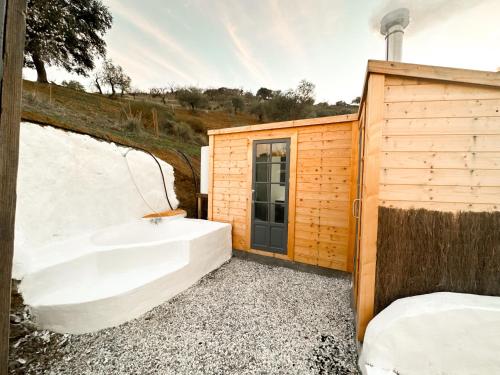 une baignoire installée à côté d'un bâtiment en bois dans l'établissement Romantic accommodation - Hottub & Sauna, à Almogía