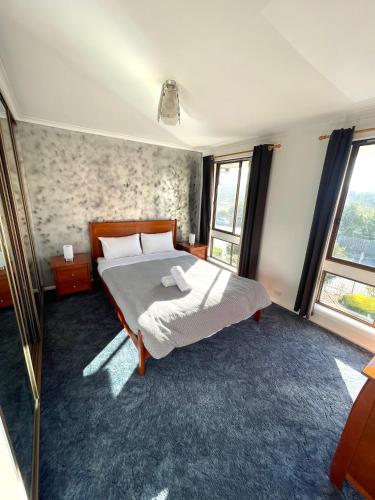 a bedroom with a bed and a large window at Relaxation Holiday Home in Bellerive in Bellerive