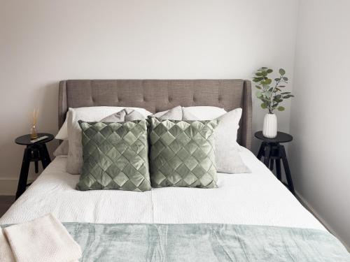 a bedroom with a bed with white sheets and pillows at Whimsical Land in London