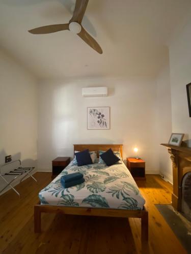 a bedroom with a bed with a ceiling fan at Somerby! in Albury
