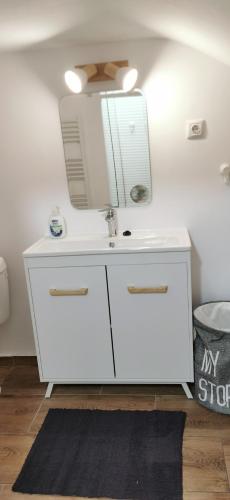 a bathroom with a white sink and a mirror at Casa Silvia in Cluj-Napoca