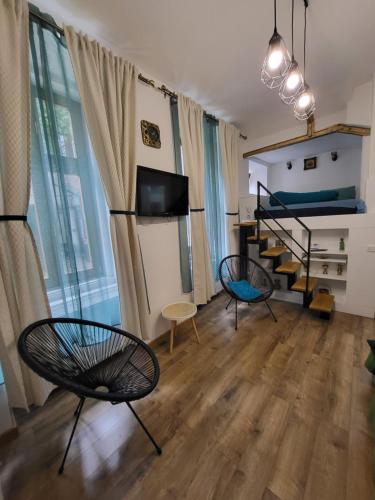 a room with two chairs and a bunk bed at Casa Silvia in Cluj-Napoca