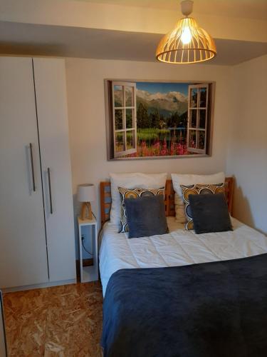 a bedroom with two beds and a lamp and windows at CHALET la VEILLA in Ax-les-Thermes