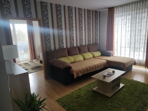 een woonkamer met een bank en een tafel bij Avantgarden1 .Apartament lux in Braşov