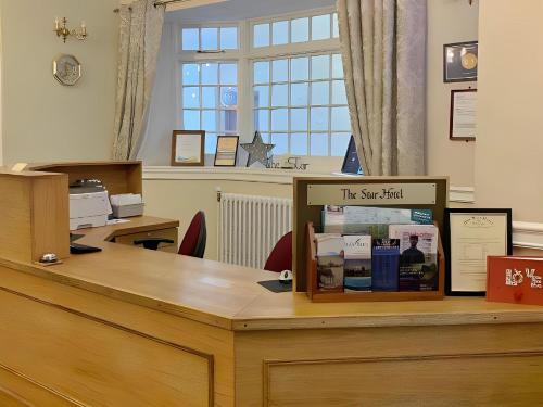 a desk with a sign on top of it at The Star Hotel in Southampton