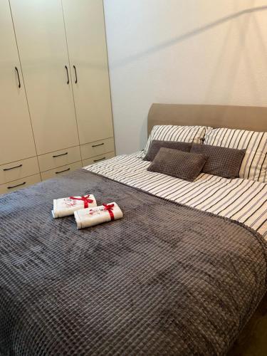 two beds in a bedroom with towels on them at Pannonica Apartman B in Tuzla