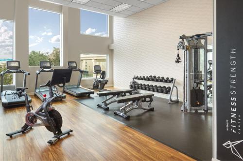 a gym with treadmills and exercise equipment in a room at Atlanta Airport Marriott Gateway in Atlanta
