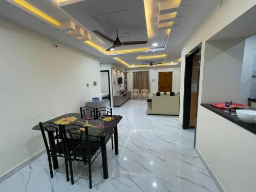 a kitchen and dining room with a table and chairs at Nirvana Home Stay in Visakhapatnam