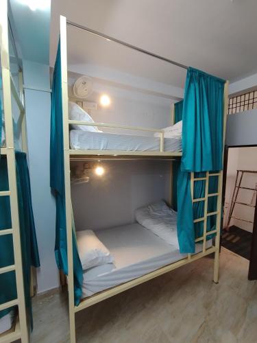 a bunk bed room with two bunk beds in it at Ganga Putra Inn in Varanasi