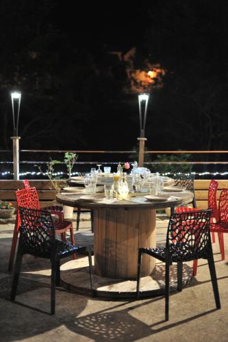a table and chairs on a deck at night at Moulin de Parayre in Les Vignes