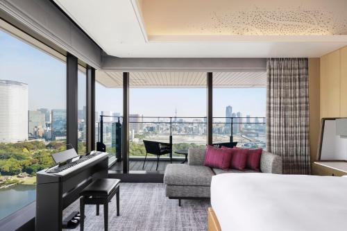 a bedroom with a piano and a living room at mesm Tokyo, Autograph Collection in Tokyo