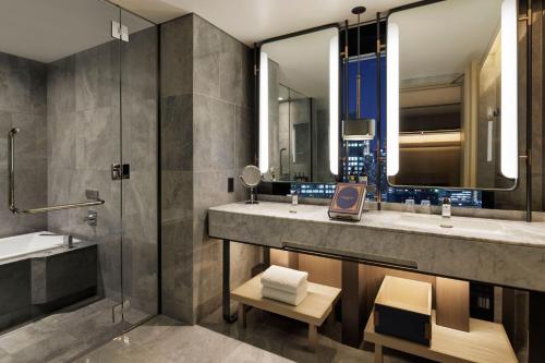 a bathroom with two sinks and a shower at mesm Tokyo, Autograph Collection in Tokyo