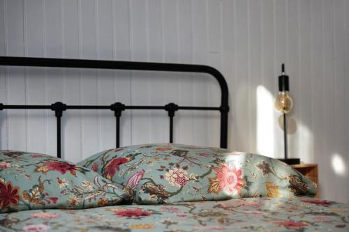 a bed with two pillows on top of it at Le Studio de la Bastide - Classé 2 étoiles - Libourne in Libourne