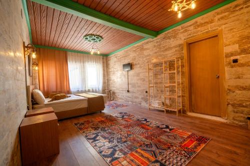 a room with a bed and a rug on the floor at ARTON İN CAPPADOCİA HOTEL in Avanos