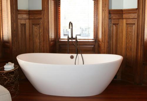 a white bath tub in a room with a window at Anchorage 1770 in Beaufort