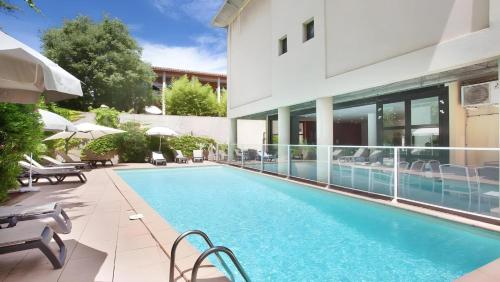 une piscine devant un immeuble dans l'établissement Ma place au sud Aix Terrasse Parking, à Aix-en-Provence