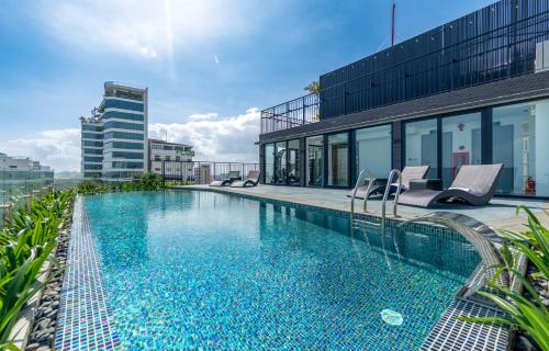 a swimming pool on top of a building at Taiyo Hotel & Apartment in Da Nang