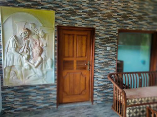 a door in a room with a painting on the wall at Heaven Palace in Kandy