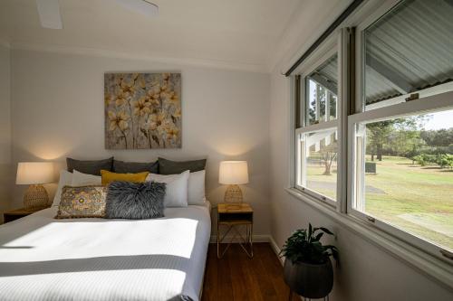 a bedroom with a large bed and a window at McCaffrey's Estate in Pokolbin