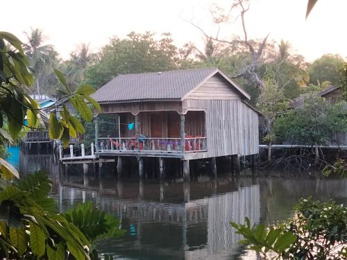 a house on a dock on a body of water at Friend of Nature Bungalow in Koh Rong Island