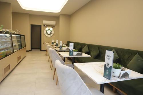 a row of tables and chairs in a restaurant at MYWAY DELUXE Alsancak in Konak