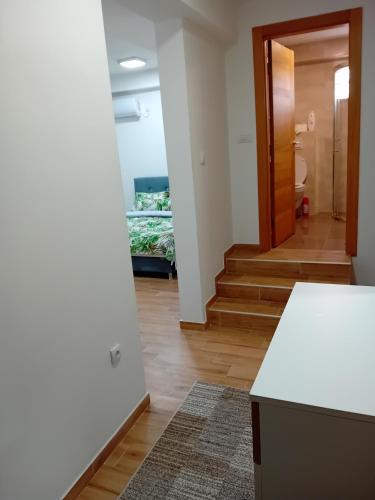 a hallway with a white counter and a room with stairs at Aura Trebinje 2 in Trebinje