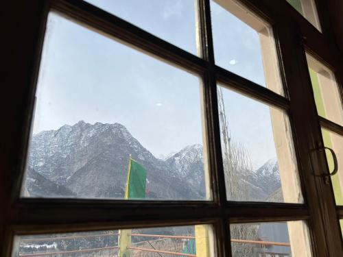 a window with a view of a mountain at SNOWFLAKE Homestay in Gondla