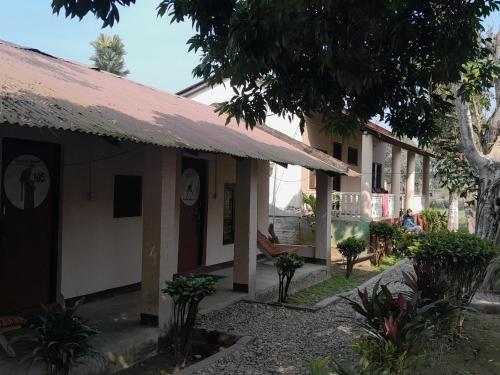 a building with a red roof at Crocodile Safari Camp in Chitwan