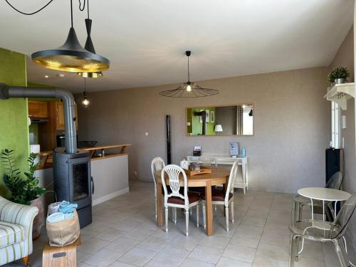 a kitchen and dining room with a table and chairs at L'Intemporel in Cernay-lès-Reims