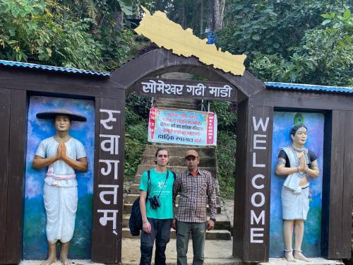a group of people standing in front of a gate at Crocodile Safari Camp in Chitwan
