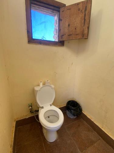 a bathroom with a toilet and a window at Blend in Nature Camp in Sharm El Sheikh