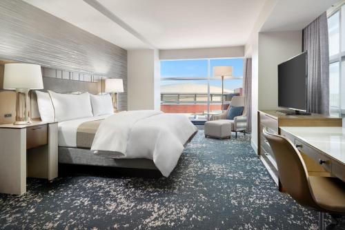 a hotel room with a large bed and a television at The Westin Memphis Beale Street in Memphis