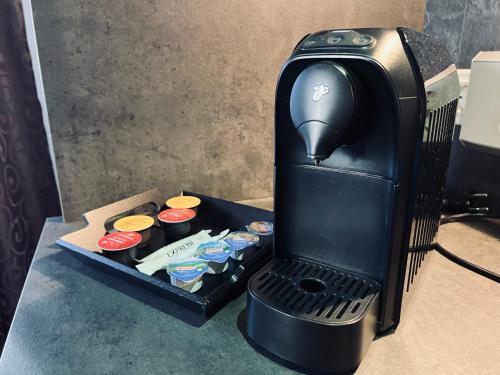 a black coffee maker sitting on top of a table at Ferienwohnung Wallmerhof am ländlichen Wimberg in Adnet