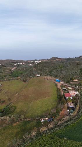 an aerial view of a field with houses on a hill at Finca el Lomo in Las Palmas de Gran Canaria