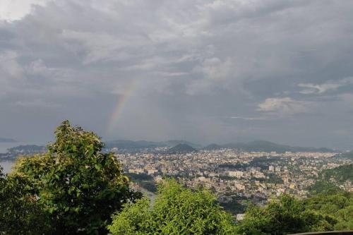 a view of a city with a rainbow in the sky at Hemalata Heritage Home in Guwahati
