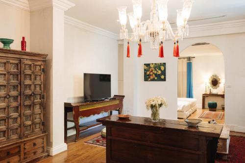 a living room with a table and a television at At Niman conceptual Home chiangmai in Chiang Mai