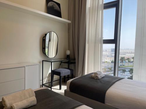 a hotel room with two beds and a mirror at ASHRI HH, Luxurious Apt in Creek in Dubai