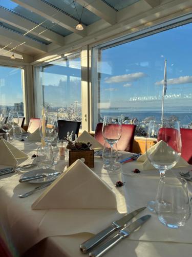a table with wine glasses and a view of the city at Best Western Hotel Rebstock in Rorschacherberg
