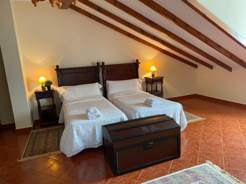 a bedroom with two beds with white sheets at LOS CARBAYINOS in Villaviciosa