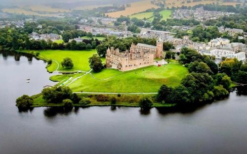 an aerial view of a castle on an island in the water at Scandi Style Duplex Sleeps 6 in Linlithgow