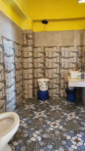 La salle de bains est pourvue de toilettes et d'un lavabo. dans l'établissement Neelkanth Retreat Mukteshwar, à Mukteswar