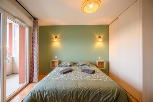 a bedroom with a bed in a room with a window at Le Capeyron - Parking - WIFI - Aéroport in Mérignac
